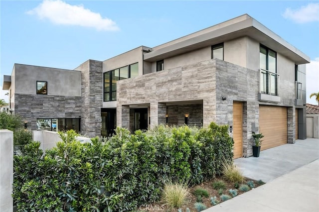 433 Harbor Island Dr, Newport Beach, CA 92660 - modern home featuring a garage, stone siding, stucco siding, and concrete driveway
