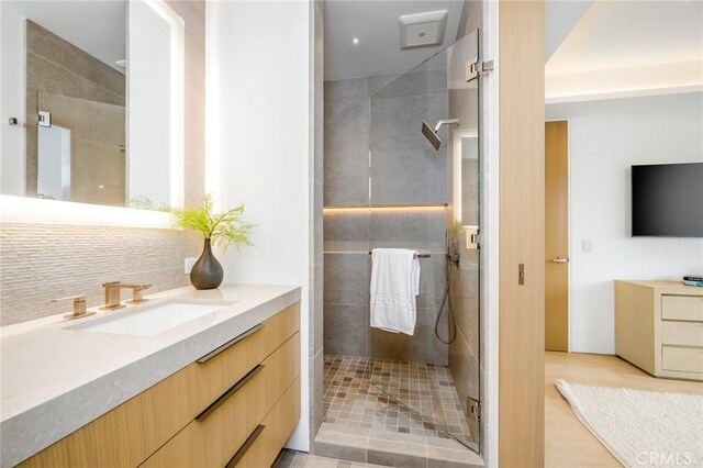 bathroom featuring vanity and tiled shower