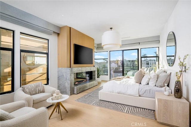 bedroom featuring light hardwood / wood-style floors and a fireplace