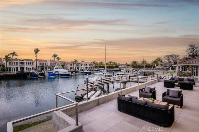 dock area featuring an outdoor living space and a water view