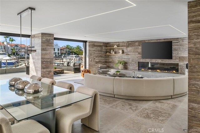 living room featuring a large fireplace and floor to ceiling windows