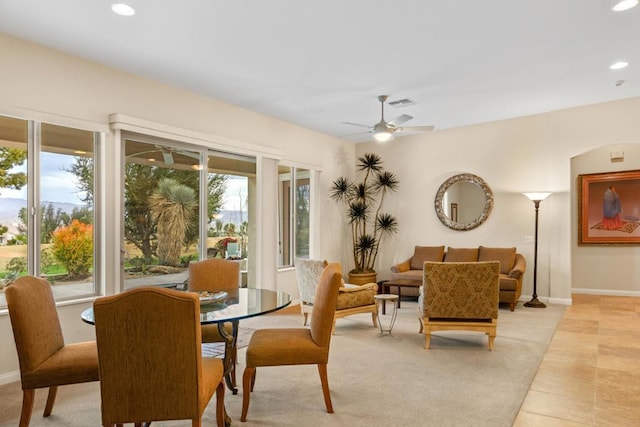 tiled dining space featuring ceiling fan