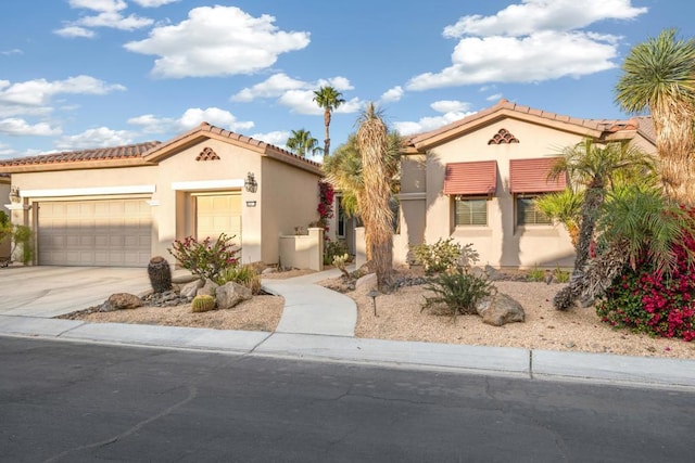 mediterranean / spanish-style home with a garage