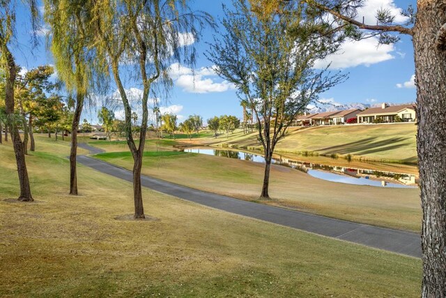 view of community featuring a water view and a yard