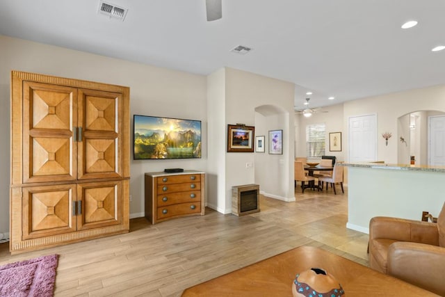 living room featuring ceiling fan and light hardwood / wood-style flooring