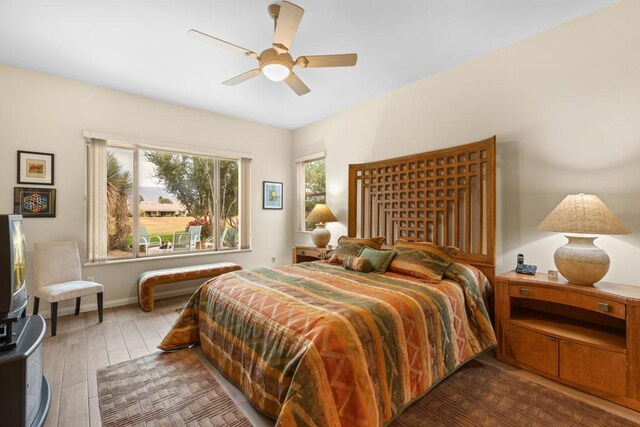 bedroom with ceiling fan and dark hardwood / wood-style floors