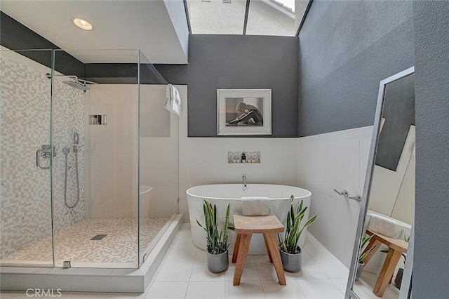 bathroom featuring tile patterned floors and shower with separate bathtub