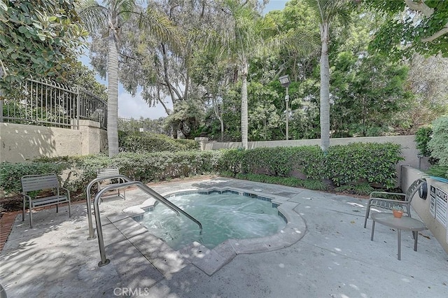 view of swimming pool featuring an in ground hot tub