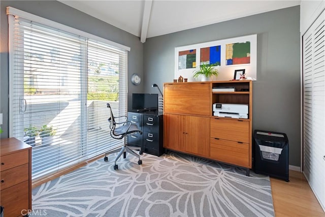 office area featuring heating unit, vaulted ceiling, and light hardwood / wood-style floors