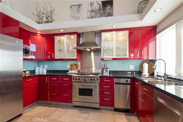 kitchen featuring wall chimney exhaust hood, stainless steel appliances, sink, and backsplash