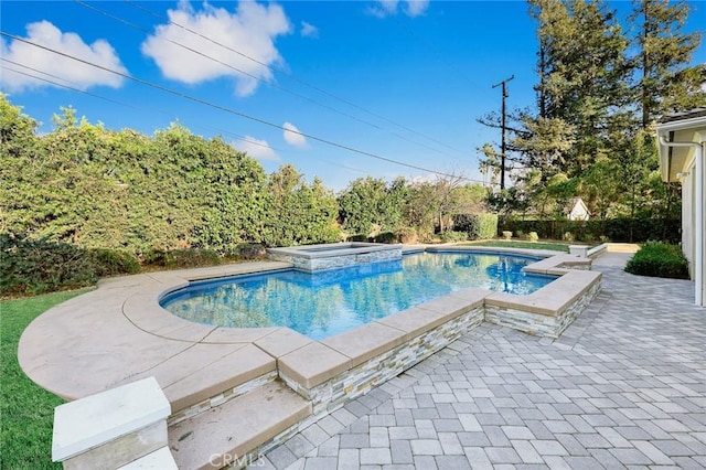 view of swimming pool with an in ground hot tub and a patio