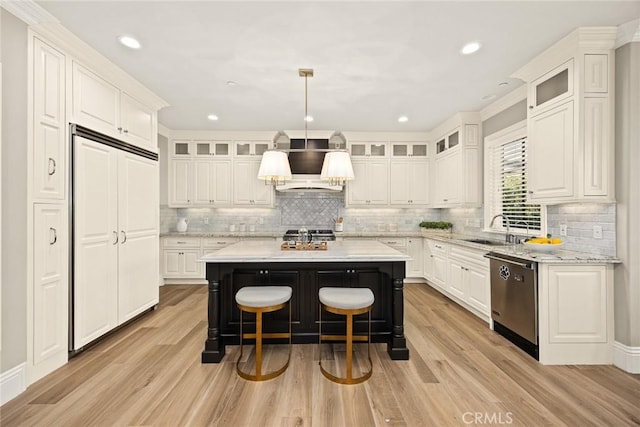 kitchen with premium range hood, a kitchen island, dishwasher, and white cabinetry