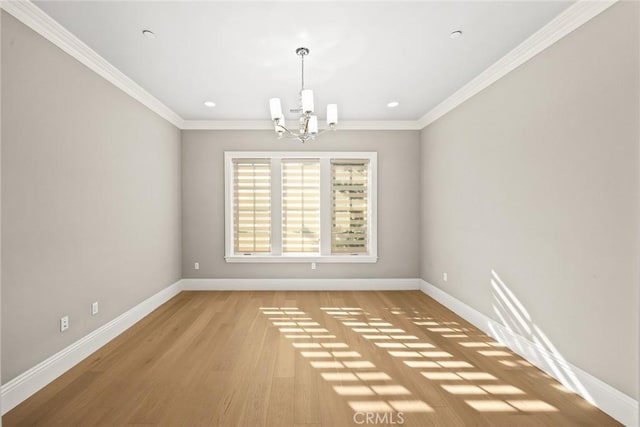 unfurnished dining area with light hardwood / wood-style floors, ornamental molding, and a chandelier