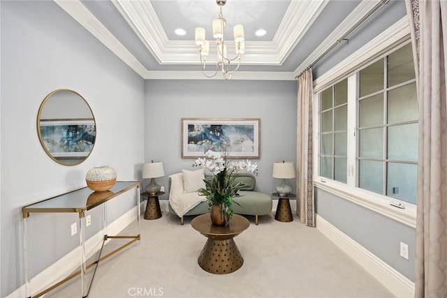 living area with ornamental molding, a raised ceiling, a notable chandelier, and carpet flooring