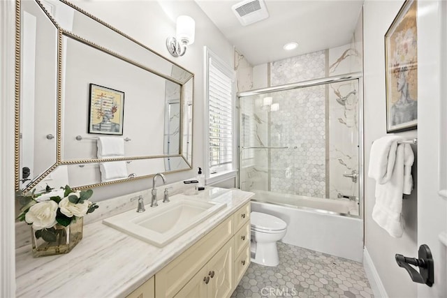 full bathroom featuring tile patterned floors, enclosed tub / shower combo, toilet, and vanity