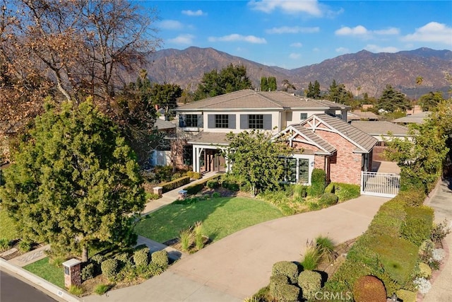 view of front facade with a front lawn and a mountain view