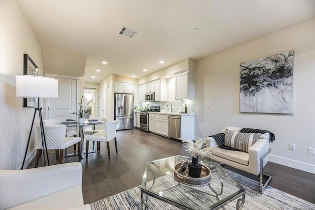 living room featuring dark hardwood / wood-style flooring and sink