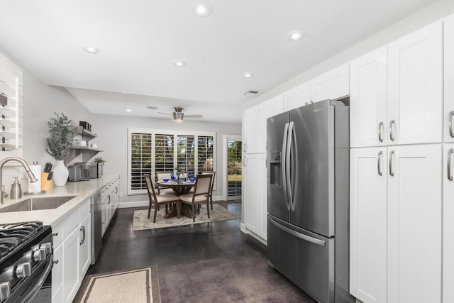 kitchen with white cabinetry, ceiling fan, stainless steel appliances, and sink