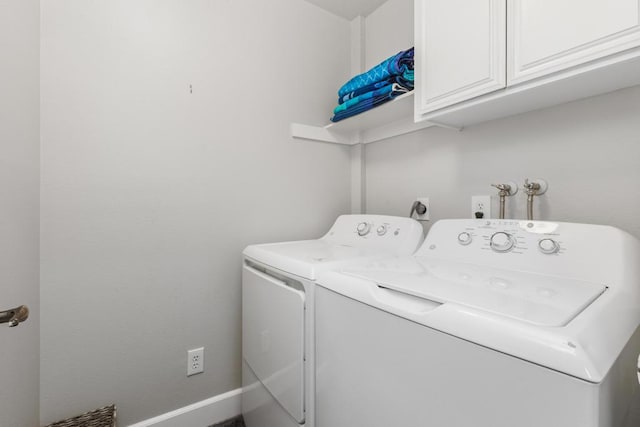 washroom with cabinets and independent washer and dryer