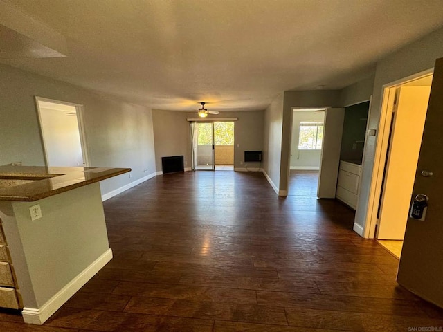 unfurnished living room with ceiling fan and dark hardwood / wood-style floors