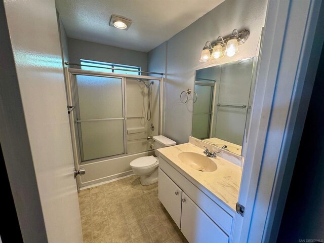 full bathroom featuring shower / bath combination with glass door, a textured ceiling, toilet, and vanity