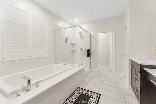 bathroom with shower with separate bathtub, tile patterned floors, and vanity