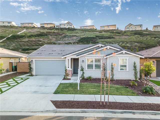 view of front of property with a garage and a front lawn