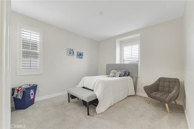 bedroom featuring light colored carpet