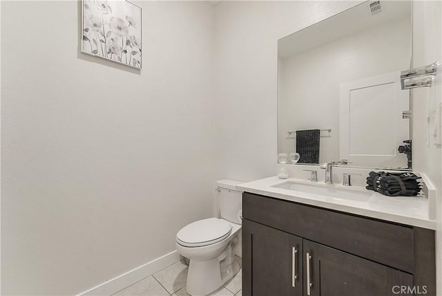 bathroom with tile patterned flooring, vanity, and toilet