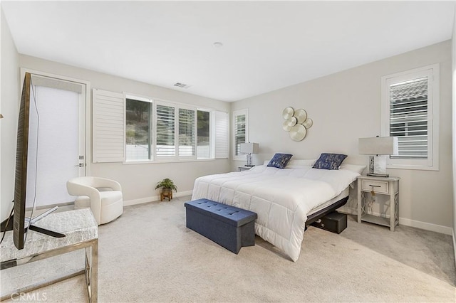 bedroom featuring light carpet