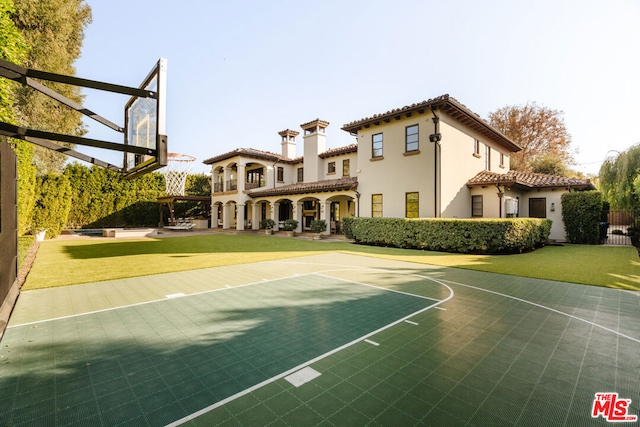 view of basketball court with a yard