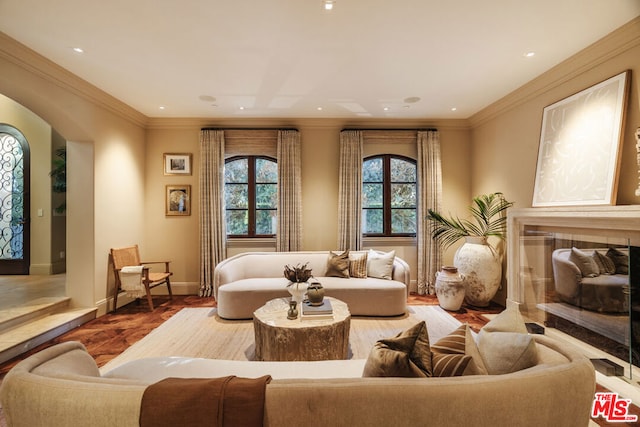 sitting room featuring a high end fireplace and crown molding