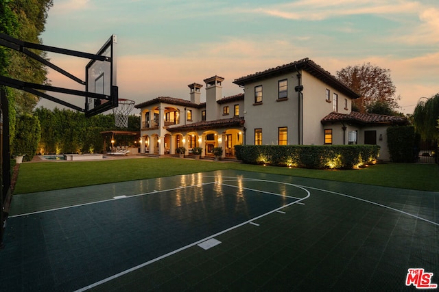 view of sport court with a yard