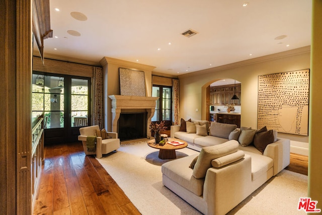 living room featuring crown molding and wood-type flooring