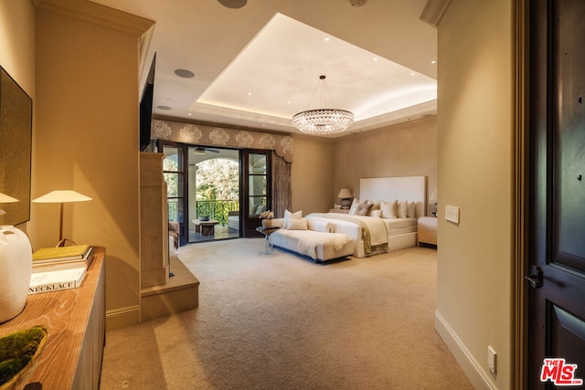 carpeted bedroom with access to exterior, a chandelier, and a tray ceiling