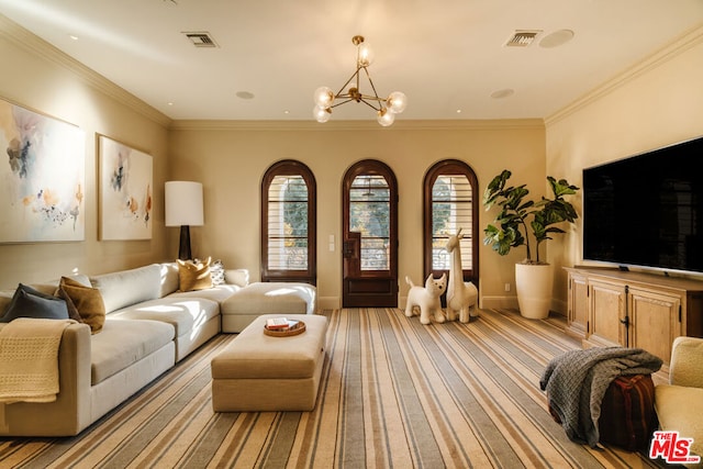 living room featuring an inviting chandelier and crown molding