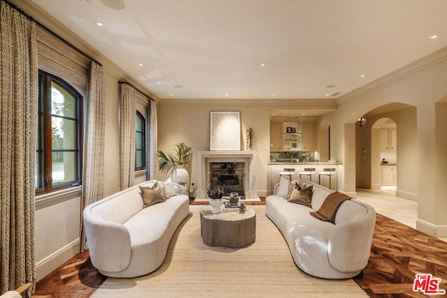 living room with light parquet floors and crown molding