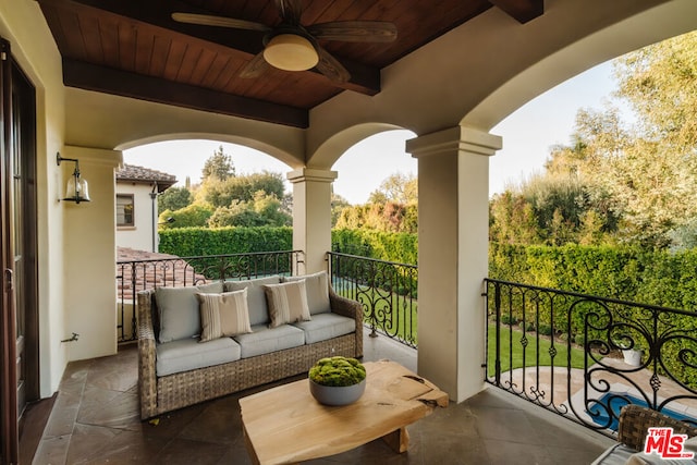 balcony featuring ceiling fan and an outdoor living space