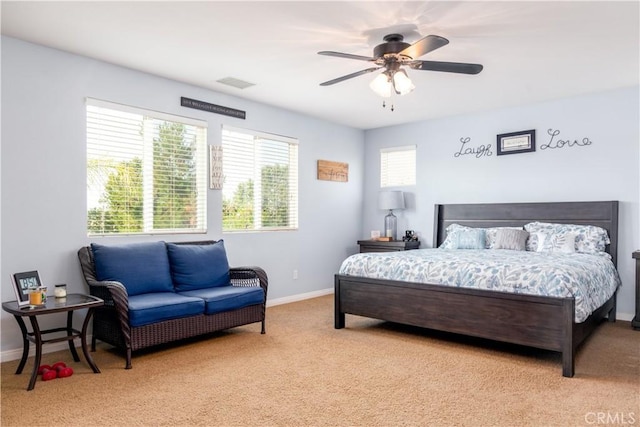 bedroom with ceiling fan and light colored carpet