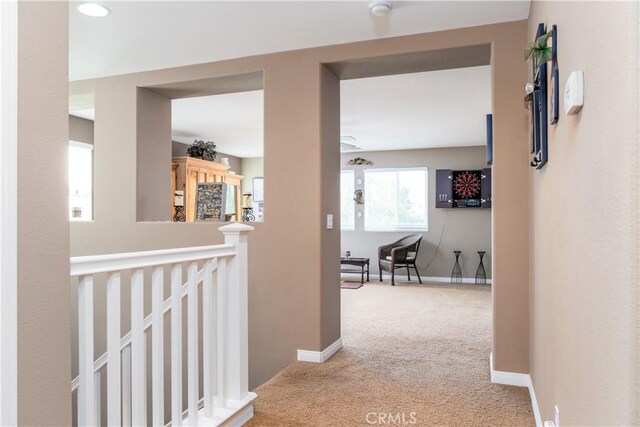 corridor with light colored carpet