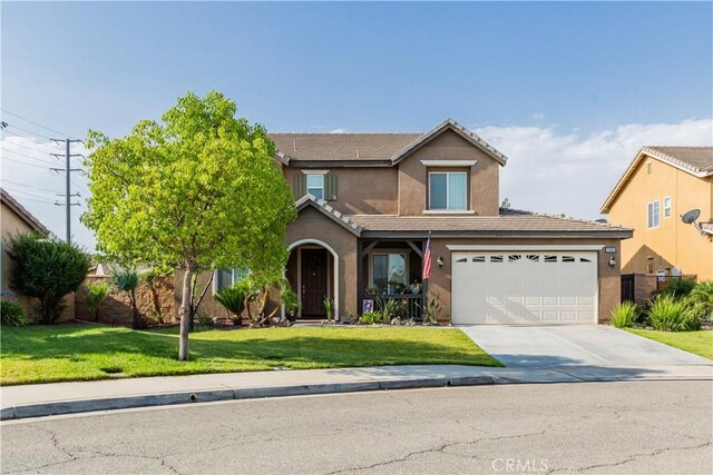 front of property featuring a garage and a front yard