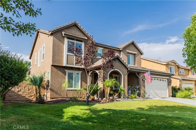 view of front of property with a front lawn and a garage