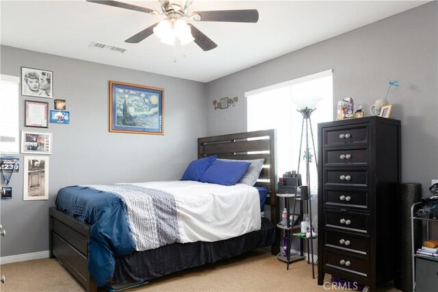 bedroom with ceiling fan and light colored carpet