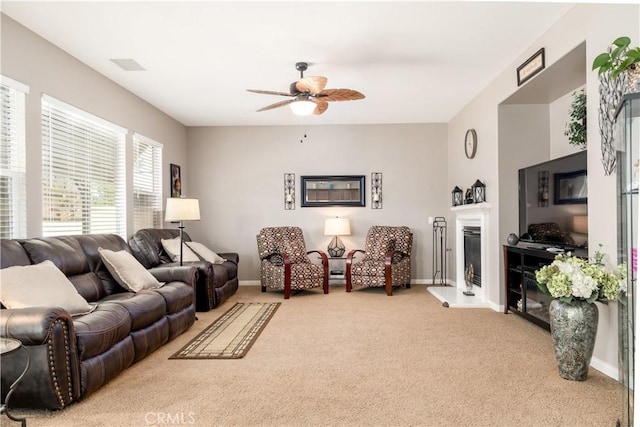 carpeted living room with ceiling fan