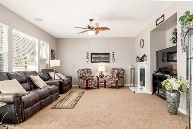 carpeted living room featuring ceiling fan