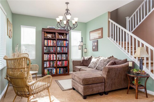 sitting room with carpet and a chandelier