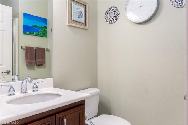 bathroom featuring toilet and vanity