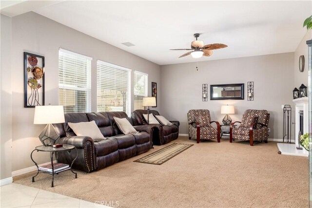 tiled living room with ceiling fan