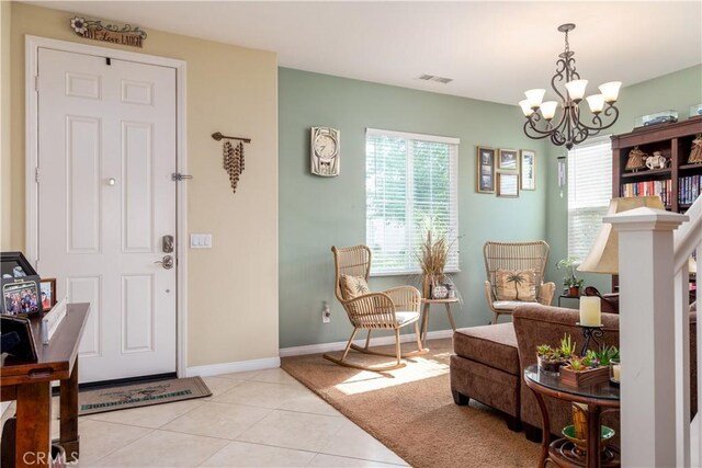 entryway featuring a wealth of natural light, an inviting chandelier, and light tile patterned flooring