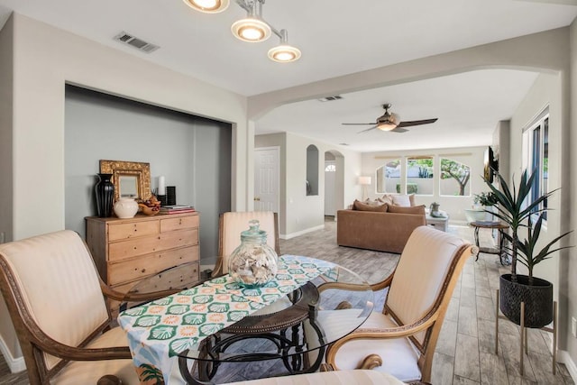 dining room with ceiling fan and light wood-type flooring